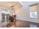 Open dining area featuring dark wood floors, a stylish light fixture, and abundant natural light at 706 E Washington St # 124, Phoenix, AZ 85034