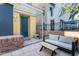 Charming home entrance with a turquoise door, brick accents, and cozy outdoor seating at 706 E Washington St # 124, Phoenix, AZ 85034