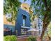 Beautiful multi-level exterior with modern architecture and a cozy outdoor patio shaded by an umbrella at 706 E Washington St # 124, Phoenix, AZ 85034