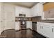 Well-lit kitchen features white cabinets, stainless steel appliances, and stylish backsplash at 706 E Washington St # 124, Phoenix, AZ 85034