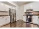 A modern kitchen showcasing stainless steel appliances, white cabinets, and dark wood flooring at 706 E Washington St # 124, Phoenix, AZ 85034