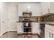 The updated kitchen with stainless steel appliances, white cabinetry, and stylish backsplash at 706 E Washington St # 124, Phoenix, AZ 85034