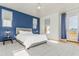 Bedroom with accent wall, a ceiling fan, and a patio door to the balcony at 706 E Washington St # 124, Phoenix, AZ 85034