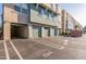 Condominium parking area showing multiple green garage doors and parking spaces at 706 E Washington St # 124, Phoenix, AZ 85034