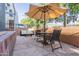 Secluded patio featuring stone flooring, stylish outdoor furniture and a shaded area with an umbrella at 706 E Washington St # 124, Phoenix, AZ 85034