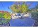 Spacious backyard featuring gravel, mature tree, desert plants, swimming pool and covered patio at 7428 E Cambridge Ave, Scottsdale, AZ 85257