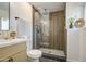 Modern bathroom with a luxurious walk-in shower featuring vertical wood paneling and a pebble floor at 7428 E Cambridge Ave, Scottsdale, AZ 85257