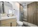 Modern bathroom featuring a walk-in shower with vertical wood paneling and a stylish vanity at 7428 E Cambridge Ave, Scottsdale, AZ 85257