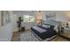 Charming bedroom featuring a large bed with a tufted headboard, light wood floors, and bright natural light at 7428 E Cambridge Ave, Scottsdale, AZ 85257