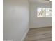 Bright, empty bedroom featuring light wood floors, a window view, and neutral walls at 7428 E Cambridge Ave, Scottsdale, AZ 85257
