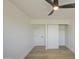 Empty bedroom featuring a modern ceiling fan, a large closet, and light wood floors at 7428 E Cambridge Ave, Scottsdale, AZ 85257