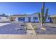 Charming single-story home featuring desert landscaping, a walkway, and a covered carport at 7428 E Cambridge Ave, Scottsdale, AZ 85257