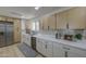 Spacious kitchen featuring stainless steel appliances, white cabinetry, and quartz countertops at 7428 E Cambridge Ave, Scottsdale, AZ 85257