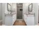 Bathroom with double sinks, vanity, and walk-in shower with stone tile at 7731 E Rose Ln, Scottsdale, AZ 85250