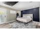 Bedroom with accent wall, plush bed, walk-out door, and contemporary decor at 7731 E Rose Ln, Scottsdale, AZ 85250
