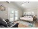 Bright bedroom with double doors to the outside, a comfy bed, and decorative art at 7731 E Rose Ln, Scottsdale, AZ 85250