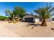 Exterior view of home with two-car garage and desert landscaping at 7731 E Rose Ln, Scottsdale, AZ 85250