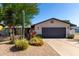 Charming home with desert landscaping, featuring a two-car garage and a well-maintained front yard at 7731 E Rose Ln, Scottsdale, AZ 85250