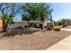 Desert landscaping accents this home with gravel front yard and a two-car garage at 7731 E Rose Ln, Scottsdale, AZ 85250