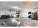 Spacious garage with laundry area and ample storage, showcasing a silver sports car at 7731 E Rose Ln, Scottsdale, AZ 85250