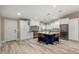 Bright kitchen with stainless steel appliances, island with seating, and white cabinets at 7731 E Rose Ln, Scottsdale, AZ 85250