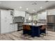 Beautiful white kitchen with stainless steel appliances and a navy blue island with seating at 7731 E Rose Ln, Scottsdale, AZ 85250