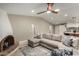 Spacious living room with a sectional, brick fireplace, and views into the kitchen area at 7731 E Rose Ln, Scottsdale, AZ 85250