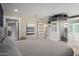 Spacious main bedroom boasts a large bed, ceiling-mounted TV, closet with glass doors, and ensuite bathroom at 7731 E Rose Ln, Scottsdale, AZ 85250