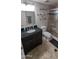 A bathroom featuring a dark colored sink cabinet, travertine floors, and a glass enclosed shower at 7910 E Camelback Rd # 302, Scottsdale, AZ 85251