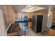 A kitchen with stainless steel appliances, wood cabinets, granite countertops, and light hardwood flooring at 7910 E Camelback Rd # 302, Scottsdale, AZ 85251