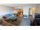 A living room with tan colored couches, a view into the kitchen, with a small view into the unit's foyer at 7910 E Camelback Rd # 302, Scottsdale, AZ 85251