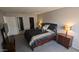A main bedroom with a black colored bed, small bedside tables, and a view into the bathroom at 7910 E Camelback Rd # 302, Scottsdale, AZ 85251