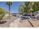 Beautiful backyard featuring a relaxing hammock, covered patio, desert landscaping, and a bocce ball court at 8137 E Indian School Rd, Scottsdale, AZ 85251