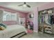 Stylish pink bedroom featuring a cozy bed, closet with plentiful storage, and unique decor at 8137 E Indian School Rd, Scottsdale, AZ 85251
