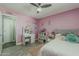 Charming pink bedroom with a vanity, cozy bed, and whimsical décor at 8137 E Indian School Rd, Scottsdale, AZ 85251