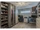 Custom closet and office area boasts sleek storage, modern lighting, and plenty of room for organization at 8137 E Indian School Rd, Scottsdale, AZ 85251