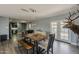 Dining room with a rustic table, modern lighting, and easy access to both the kitchen and backyard at 8137 E Indian School Rd, Scottsdale, AZ 85251