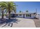 Single-story home with a spacious concrete driveway and a well-manicured gravel yard at 8137 E Indian School Rd, Scottsdale, AZ 85251