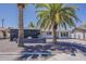 Charming single-story home with a well-maintained gravel yard and mature palm trees at 8137 E Indian School Rd, Scottsdale, AZ 85251