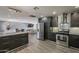 Open-concept kitchen with stainless steel appliances, ample counter space, and seamless flow to the dining area at 8137 E Indian School Rd, Scottsdale, AZ 85251