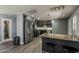 Modern kitchen with stainless steel appliances, island seating, and sleek gray cabinets at 8137 E Indian School Rd, Scottsdale, AZ 85251