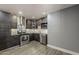 Modern kitchen with stainless steel appliances, granite countertops, and sleek gray cabinets at 8137 E Indian School Rd, Scottsdale, AZ 85251