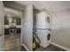 Efficient laundry area with stacked washer and dryer, conveniently located near the modern kitchen with stainless steel appliances at 8137 E Indian School Rd, Scottsdale, AZ 85251