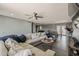 Open-concept living space with modern furniture, ceiling fan, and view of dining area and kitchen at 8137 E Indian School Rd, Scottsdale, AZ 85251