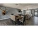 Open-concept living space with a comfortable seating area, dining area, and a large TV at 8137 E Indian School Rd, Scottsdale, AZ 85251