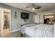 Main bedroom features an ensuite bath, walk-in closet, a ceiling fan, and hardwood floors at 8137 E Indian School Rd, Scottsdale, AZ 85251