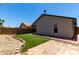 Backyard featuring manicured artificial turf, rock landscaping, and a brick paver patio at 8720 W Willowbrook Dr, Peoria, AZ 85382