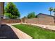 Spacious backyard with artificial turf, brick walkways, and privacy wall, perfect for entertaining at 8720 W Willowbrook Dr, Peoria, AZ 85382