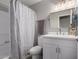 Bright bathroom featuring a white vanity, framed mirror, and a shower/tub combination with a patterned curtain at 8720 W Willowbrook Dr, Peoria, AZ 85382