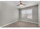 Well-lit bedroom with soft carpet, ceiling fan, and large window providing ample natural light at 8720 W Willowbrook Dr, Peoria, AZ 85382